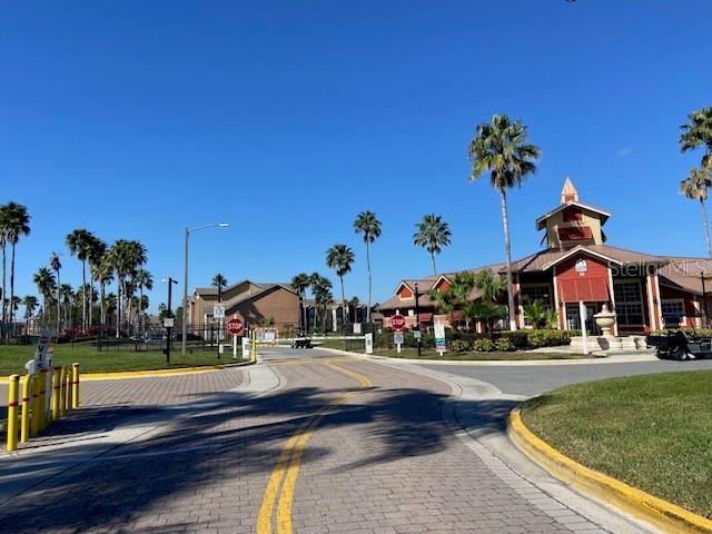 2210 Grand Cayman Ct Unit 1722, Kissimmee, FL 34741 - view of decorative street featuring traffic signs, curbs, and street lights