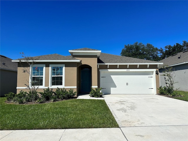 view of front of property with a front lawn and a garage