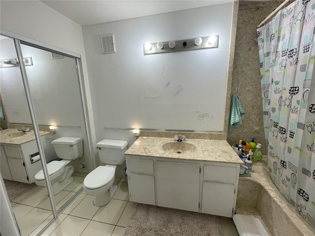 bathroom with tile patterned flooring, a shower with curtain, vanity, and toilet