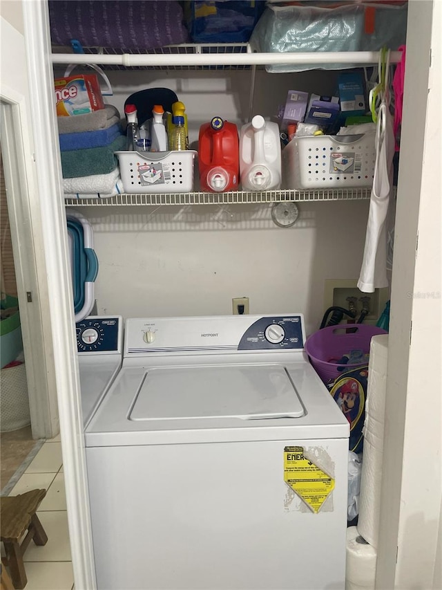 laundry area with tile patterned floors and washer / clothes dryer