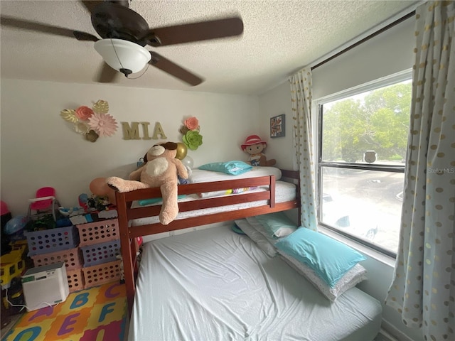 bedroom featuring a textured ceiling and ceiling fan