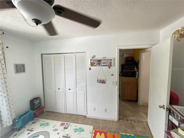 interior space with a textured ceiling, a closet, and ceiling fan