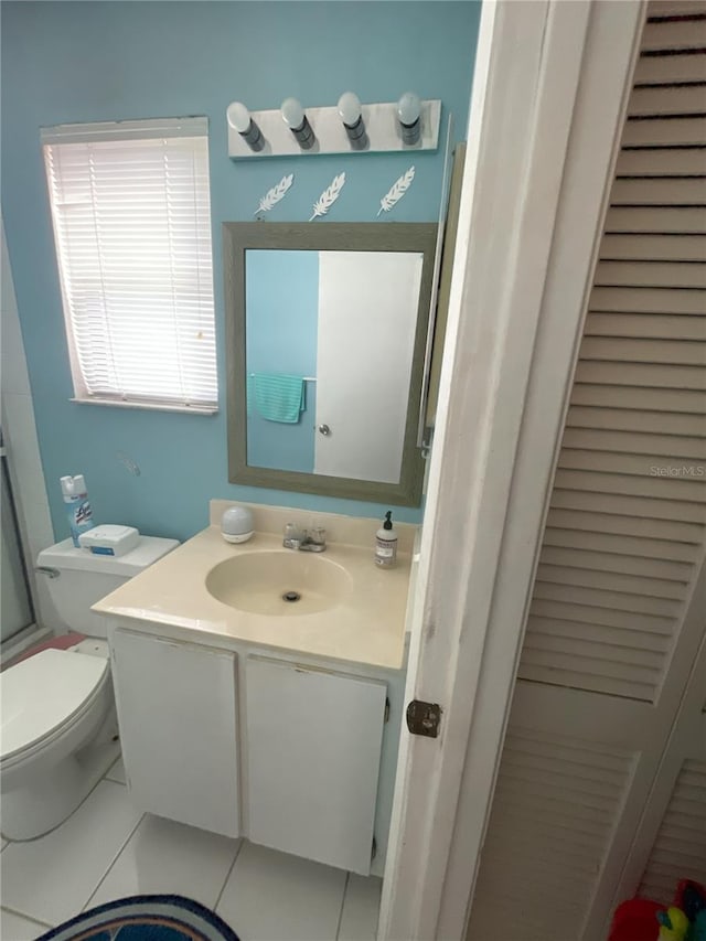 bathroom with tile patterned floors, vanity, and toilet