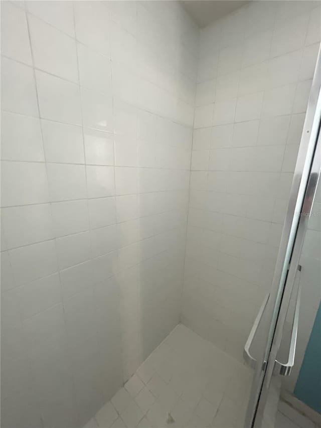 bathroom with a tile shower