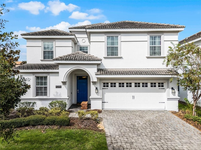 mediterranean / spanish house with a garage