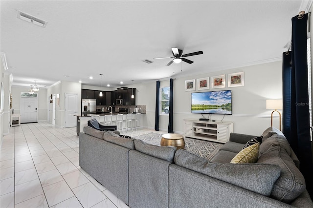 living room featuring ceiling fan, light tile patterned flooring, and ornamental molding