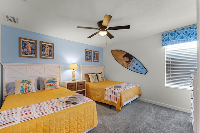 bedroom featuring multiple windows, ceiling fan, carpet floors, and a textured ceiling