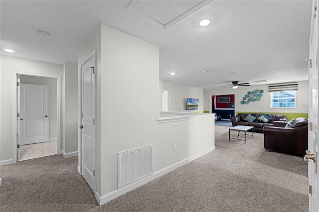 hallway featuring a textured ceiling and carpet