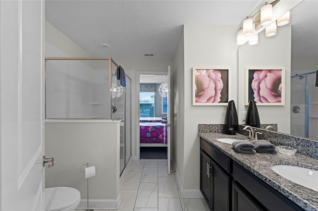 bathroom featuring vanity, walk in shower, toilet, and a textured ceiling