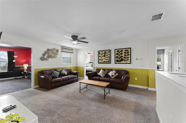 living room with ceiling fan and carpet flooring