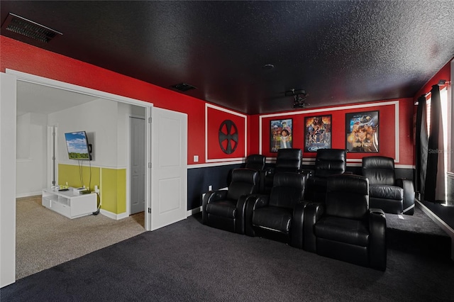 cinema with a textured ceiling and carpet