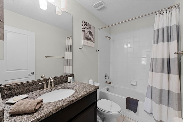 full bathroom with shower / bath combination with curtain, vanity, a textured ceiling, tile patterned floors, and toilet