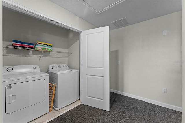 clothes washing area featuring carpet floors and washer and dryer