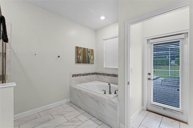 bathroom featuring tiled tub