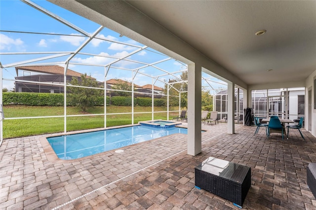 view of pool with an in ground hot tub, glass enclosure, and a patio area