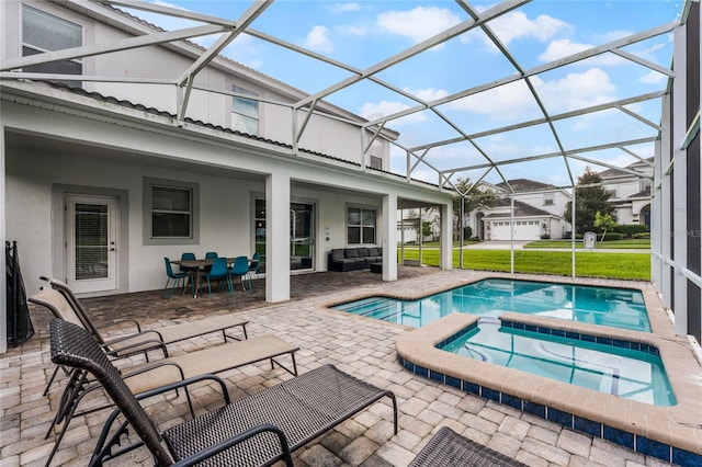 view of swimming pool featuring a lawn, an in ground hot tub, a lanai, and a patio area