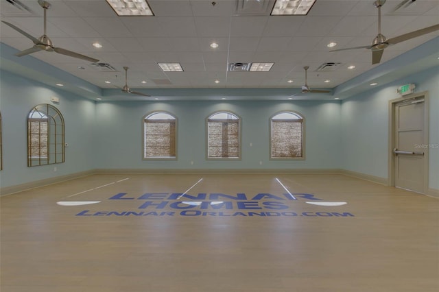 interior space with basketball court, light wood-type flooring, and ceiling fan