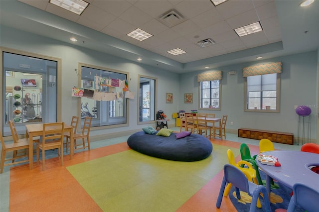 playroom featuring a tray ceiling and a paneled ceiling