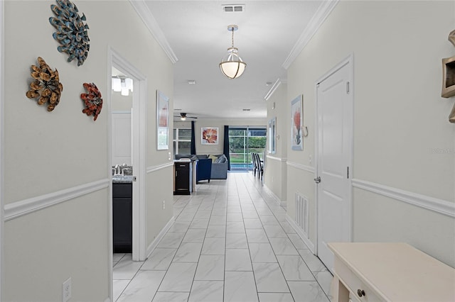 hallway featuring ornamental molding