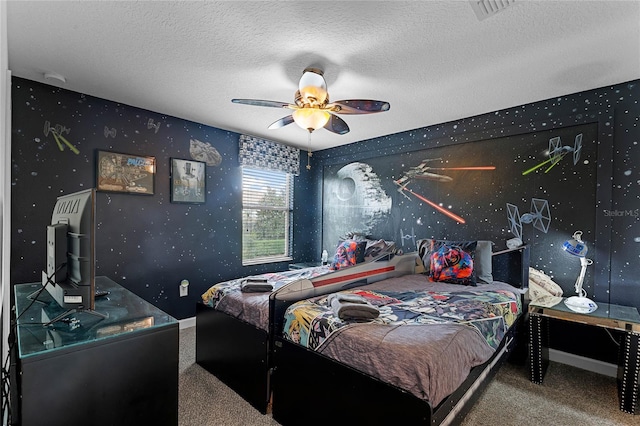 carpeted bedroom featuring ceiling fan and a textured ceiling