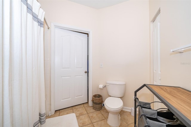 bathroom with toilet and tile patterned floors