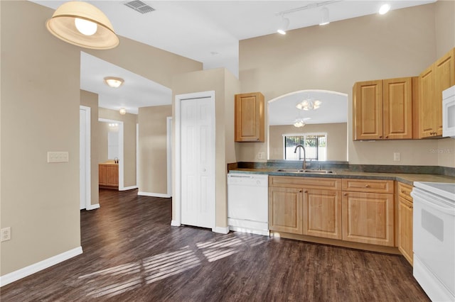 kitchen featuring sink, white appliances, rail lighting, and dark hardwood / wood-style floors