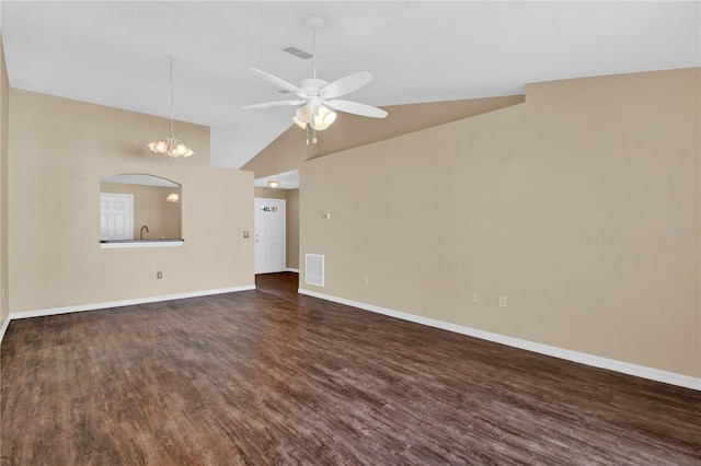 unfurnished living room with dark hardwood / wood-style floors, ceiling fan with notable chandelier, and high vaulted ceiling