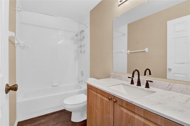 full bathroom featuring tiled shower / bath combo, vanity, wood-type flooring, and toilet