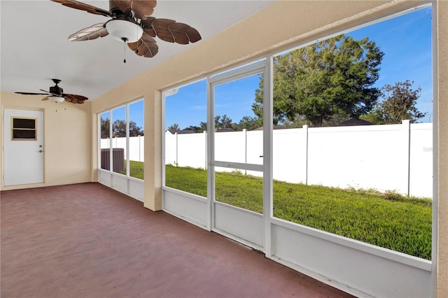 unfurnished sunroom with ceiling fan