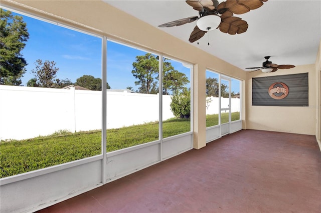 unfurnished sunroom with ceiling fan