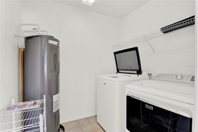 laundry room featuring water heater and independent washer and dryer