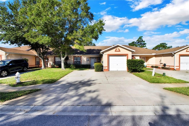 ranch-style house with a garage and a front lawn