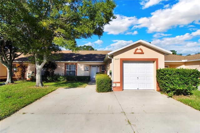 ranch-style house with a garage and a front yard