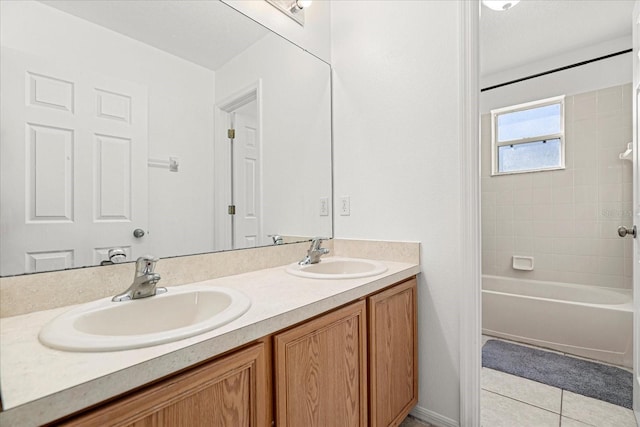 bathroom with tiled shower / bath, tile patterned floors, and vanity