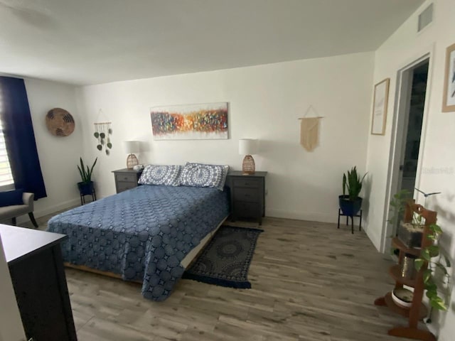 bedroom with wood-type flooring