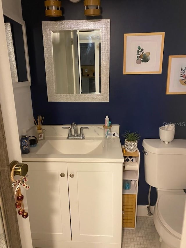 bathroom with tile patterned floors, vanity, and toilet