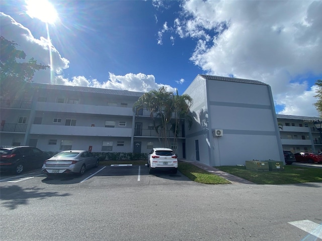 view of building exterior with uncovered parking