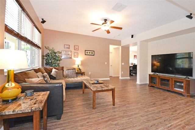 living room featuring ceiling fan and hardwood / wood-style floors