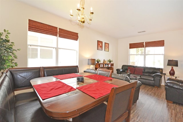 dining room with a notable chandelier and hardwood / wood-style floors