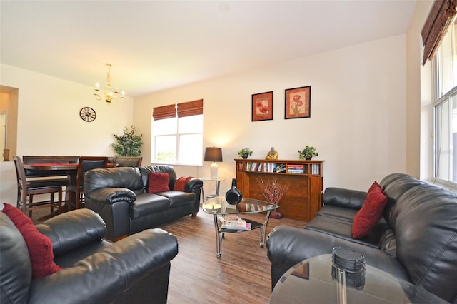 living room with an inviting chandelier and wood-type flooring