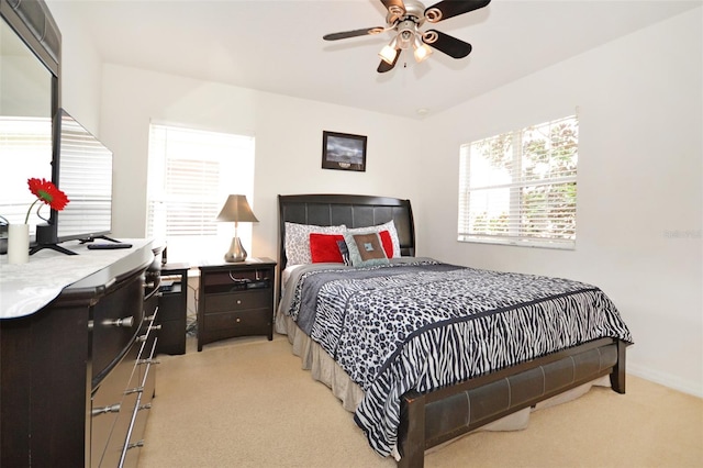 bedroom with ceiling fan and light carpet