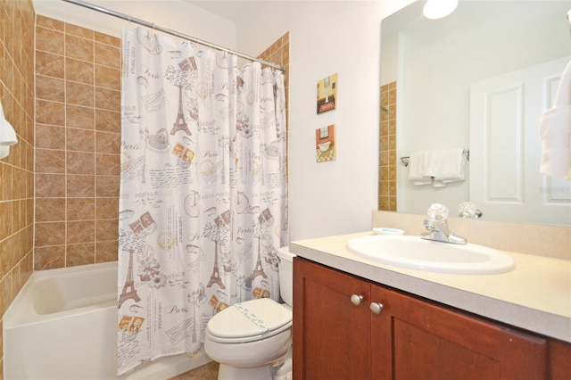 full bathroom with vanity, shower / bath combo with shower curtain, and toilet