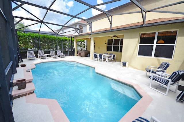 view of pool with a patio area, a lanai, and ceiling fan