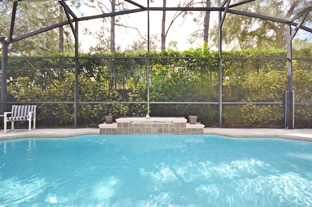 view of swimming pool featuring a lanai