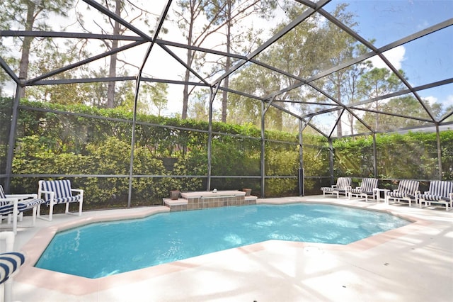 view of swimming pool featuring a lanai and a patio area