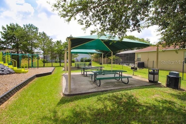 surrounding community with a playground, a lawn, and a patio area