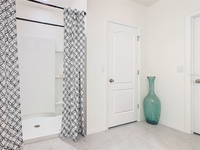 bathroom with tile patterned floors and a shower with shower curtain