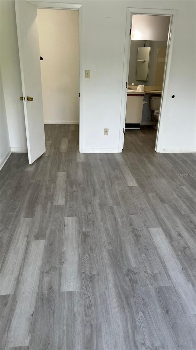 spare room featuring wood-type flooring