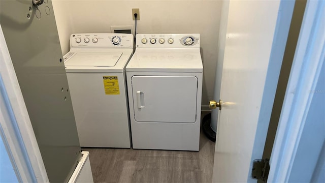 washroom with dark wood-type flooring and washing machine and clothes dryer