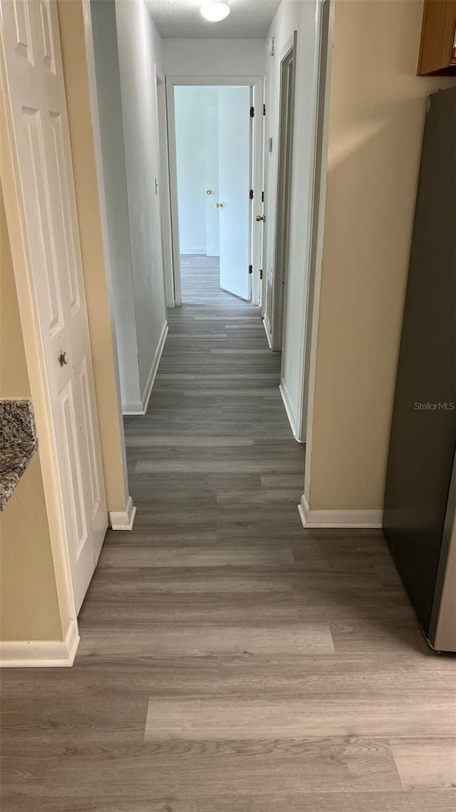 corridor with light wood-type flooring